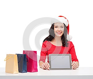 Woman in santa helper hat with tablet pc