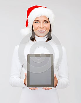 Woman in santa helper hat with tablet pc