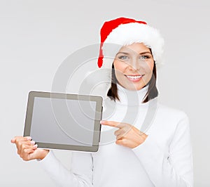 Woman in santa helper hat with tablet pc