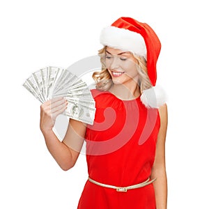 Woman in santa helper hat with us dollar money