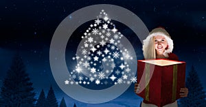 Woman Santa holding magical gift and Snowflake Christmas tree pattern shape glowing in Winter night