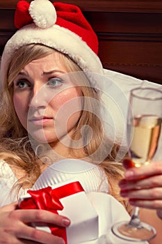 Woman in Santa's hats remain all alone photo