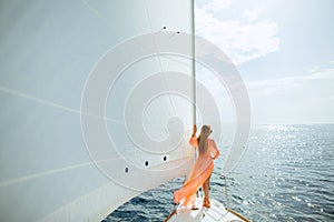 Woman in sarong yachting white sails luxury travel