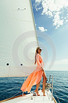 Woman in sarong yachting white sails luxury travel