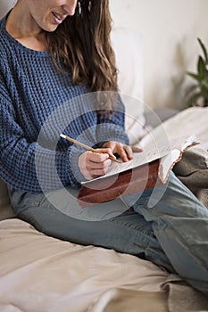 Woman sat writing in her journal