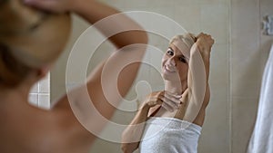 Woman satisfied with soft skin of armpit, high quality antiperspirant, body care