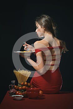 The woman savors the spaghetti with a sensual touch. She enjoys each bite of the pasta in a sensual manner. Food sensual photo