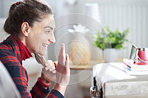 Woman saying hello with hands to a cell phone