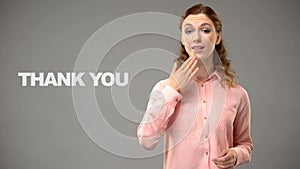 Woman saying thank you in sign language, text on background, communication photo