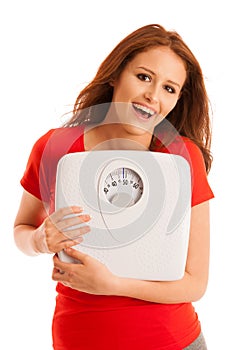 Woman with scale happy with her weight isolated over white background