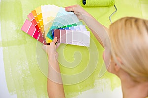 Woman with scale of paint swatches