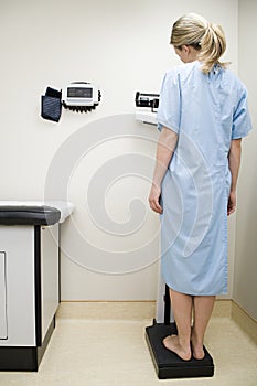 Woman on scales in examination room