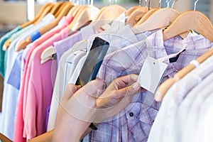 Woman scanning bar code with her mobile phone