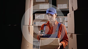 Woman scanning barcode from boxes with labels in modern warehouse