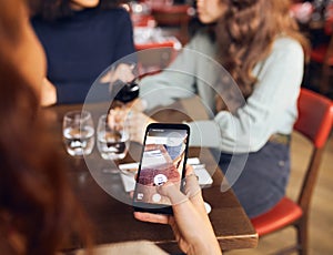 Woman scanning qr code in wine bar