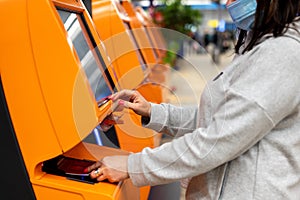 Woman scans her passport at the airline counter for self check-in at the airport. woman travelling by plane and doing self check