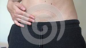 Woman with scar on her belly from c-section. Skinny fit abdomen. Postpartum recovery