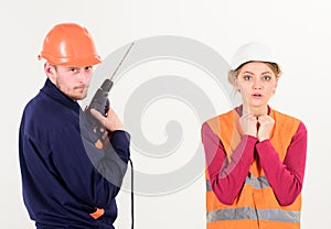 Woman with scared face in helmet, hard hat.