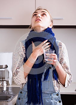 Woman in scarf gargling throat with domestic soda