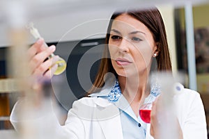 Woman scientist carrying out experiment in research laboratory