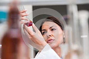 Woman scientist carrying out experiment in research laboratory