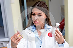 Woman scientist carrying out experiment in research laboratory