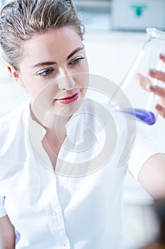 Woman scientist holding glass utensil