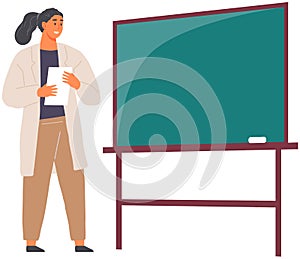 Woman scientist in lab coat stands near blackboard. Teacher conducts chemistry, science lesson