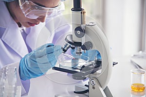 Woman scientist in lab look at science microscope medical test and research biology chemistry. Females technician laboratory