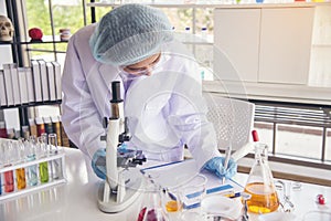 Woman scientist in lab look at science microscope medical test and research biology chemistry. Females technician laboratory