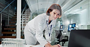 Woman, scientist and laptop in laboratory with writing, reading or data analysis for pharma research. Mature person, lab