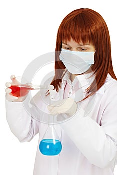 Woman - scientist mixes poisonous solutions photo