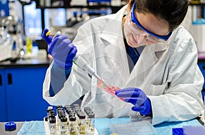 Woman scientist performing biomedical research in laboratory