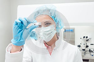 Woman scientist showing her newest biotech experiment in lab