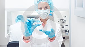 Woman scientist showing her newest biotech experiment in lab photo