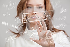 Woman scientist or student working with various high school maths and science formula.