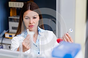 Woman scientist carrying out experiment in research laboratory