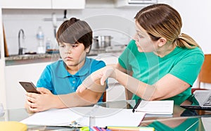 Woman scolding boy at kitchen