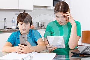 Woman scolding boy at kitchen