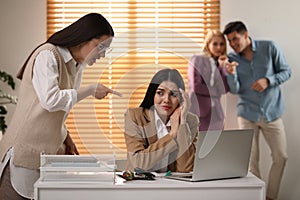 Woman scolding employee at workplace