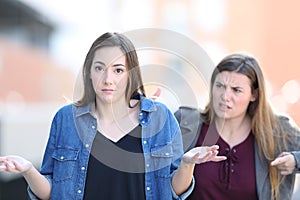 Woman scolding her confused friend who looks at you