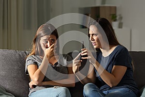 Woman scolding her friend about phone content