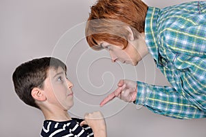 Woman scolding a scared young boy