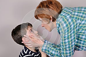 Woman scolding a scared young boy