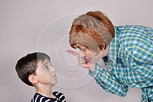 Woman scolding a scared young boy photo