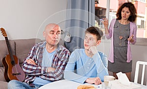 Woman scolding son and husband