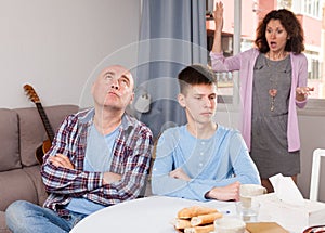 Woman scolding son and husband