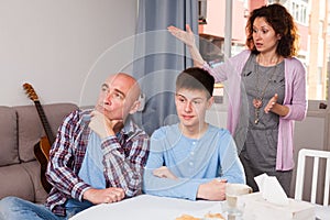 Woman scolding son and husband