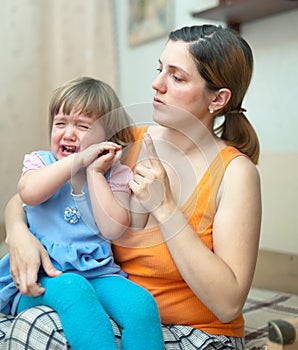 Woman scolds crying child in home