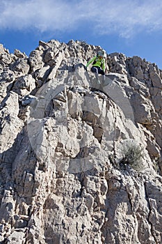 Woman Scrambling Down Cliff